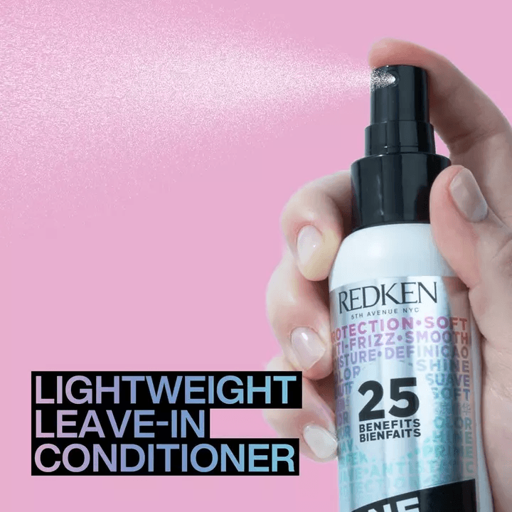 Redken lightweight leave-in conditioner spraying from bottle